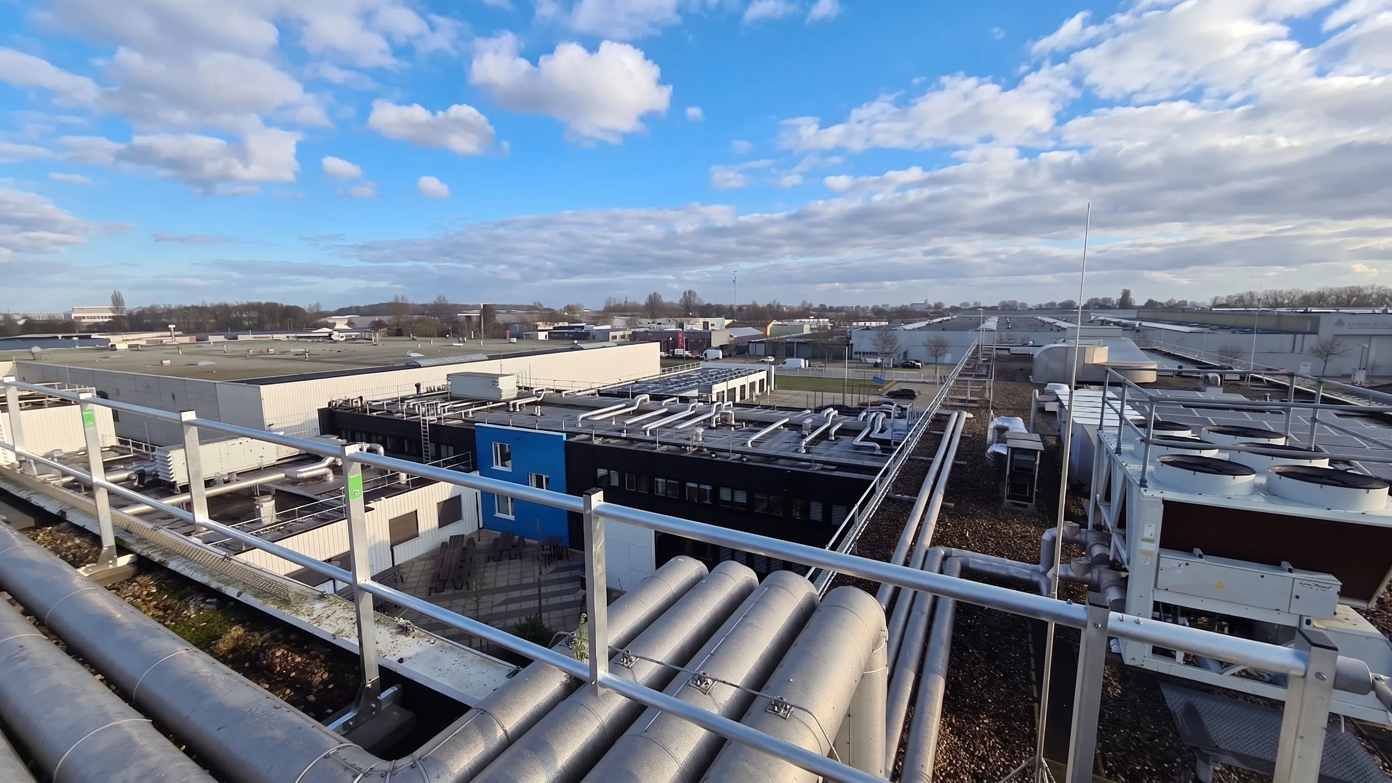 Rooftop plant and pipework on the Agilent complex, enclosed by Protector Guardrail roof-edge protection.
