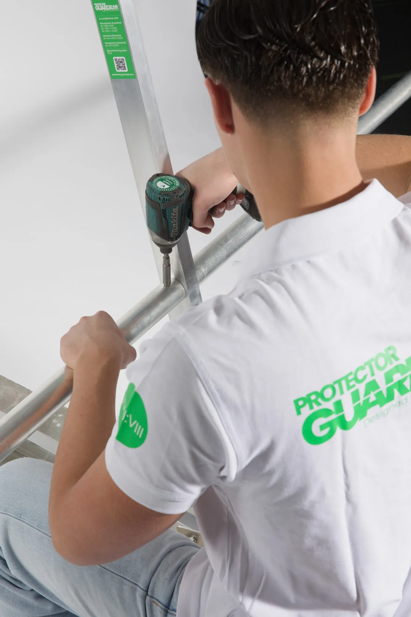 Installers mounting Protector Guardrail on a flat roof