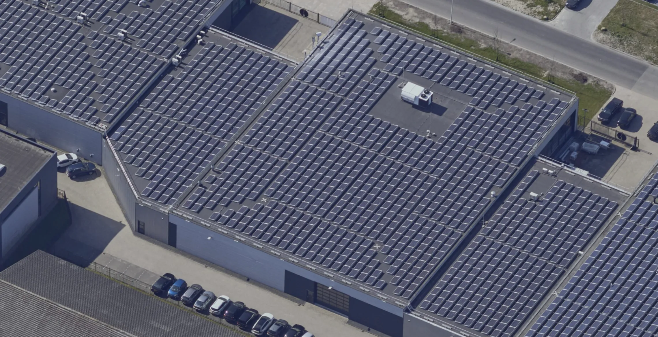 Aerial view of the solar-panel-covered production roof at Probo, with Protector Guardrail roof-edge protection along the perimeter.