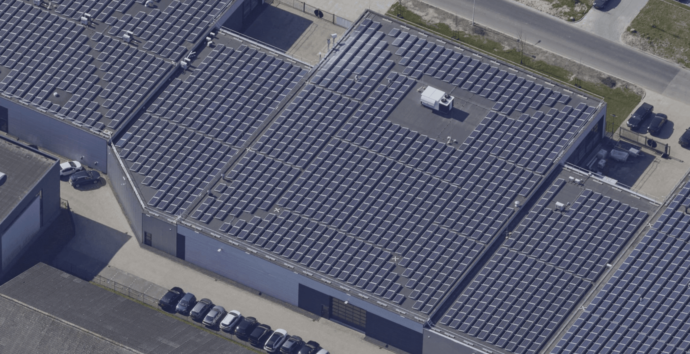 Aerial view of the solar-panel-covered production roof at Probo, with Protector Guardrail roof-edge protection along the perimeter.