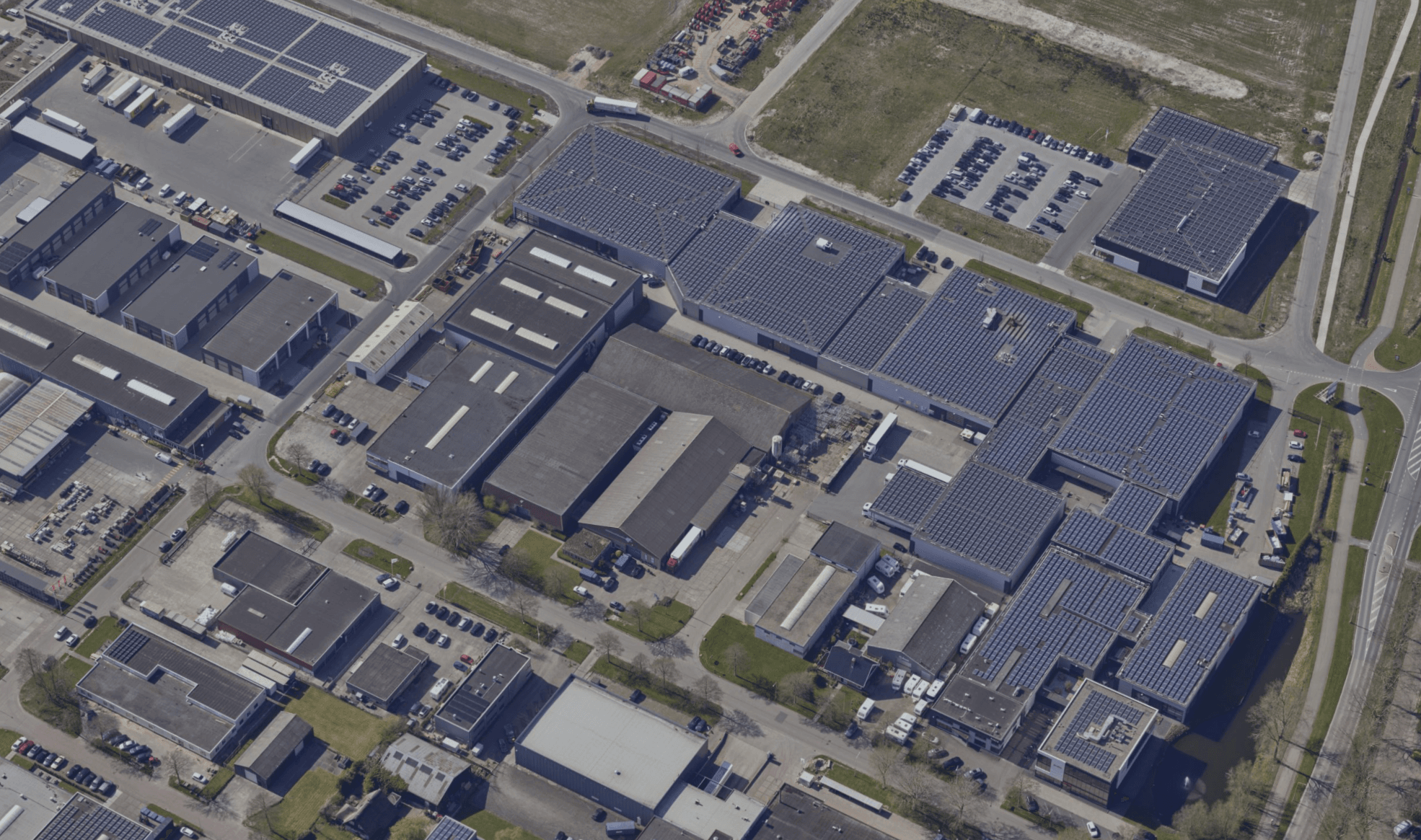 Aerial overview of the Probo production site with large roofs covered in solar panels.
