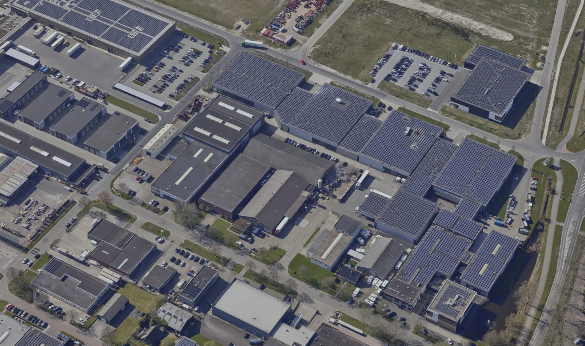 Aerial overview of the Probo production site with large roofs covered in solar panels.