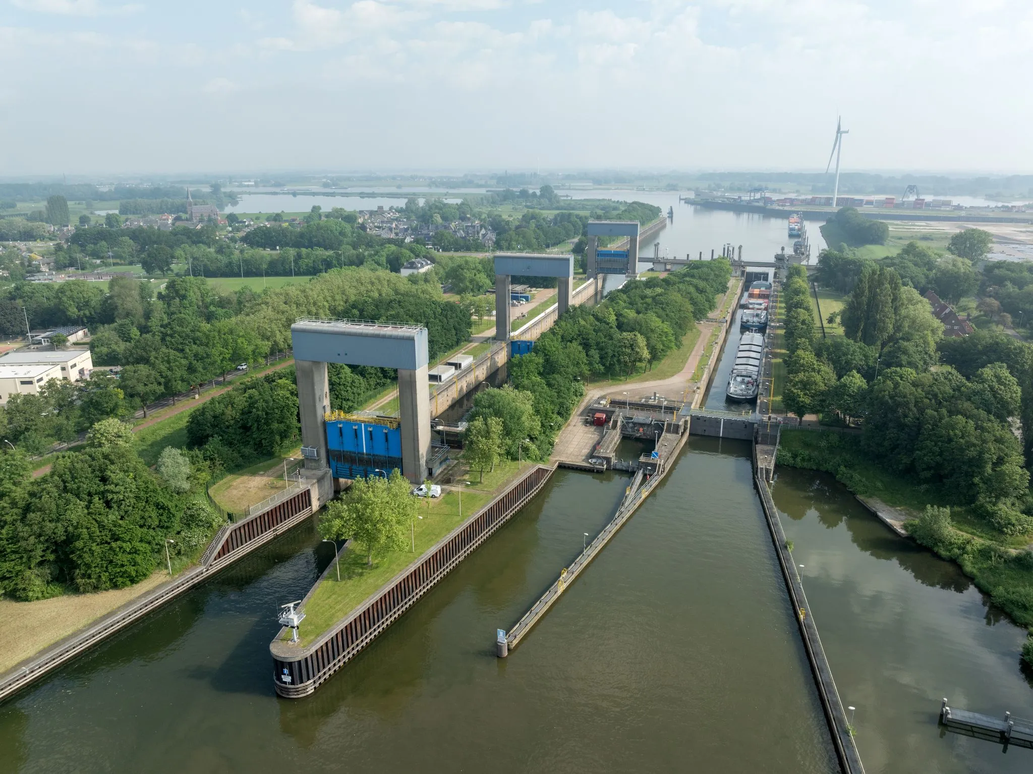 Aerial view of the Weurt lock complex near Nijmegen, showing the lock chamber and lifting gates in the canal.