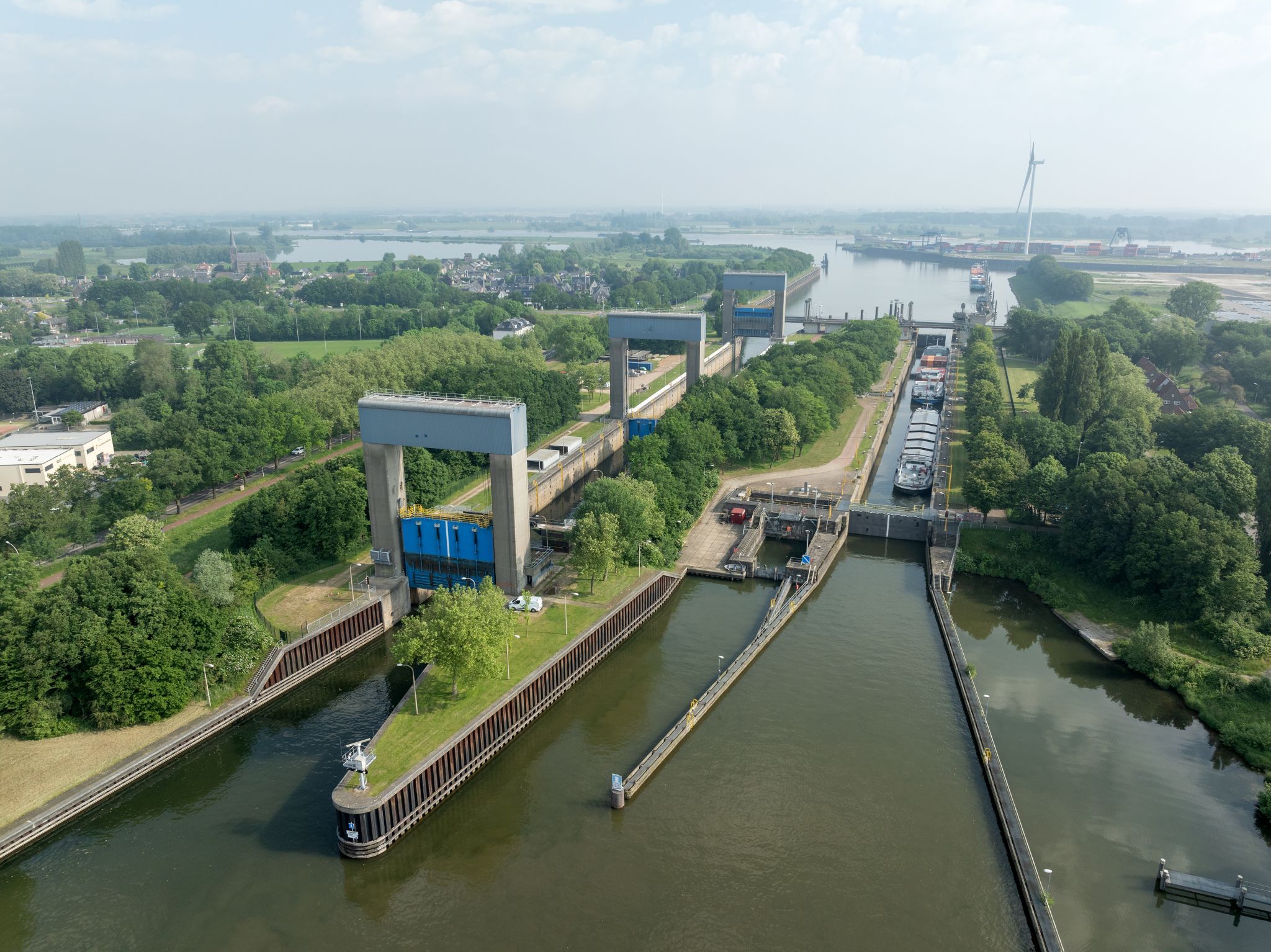 Aerial view of the Weurt lock complex near Nijmegen, showing the lock chamber and lifting gates in the canal.