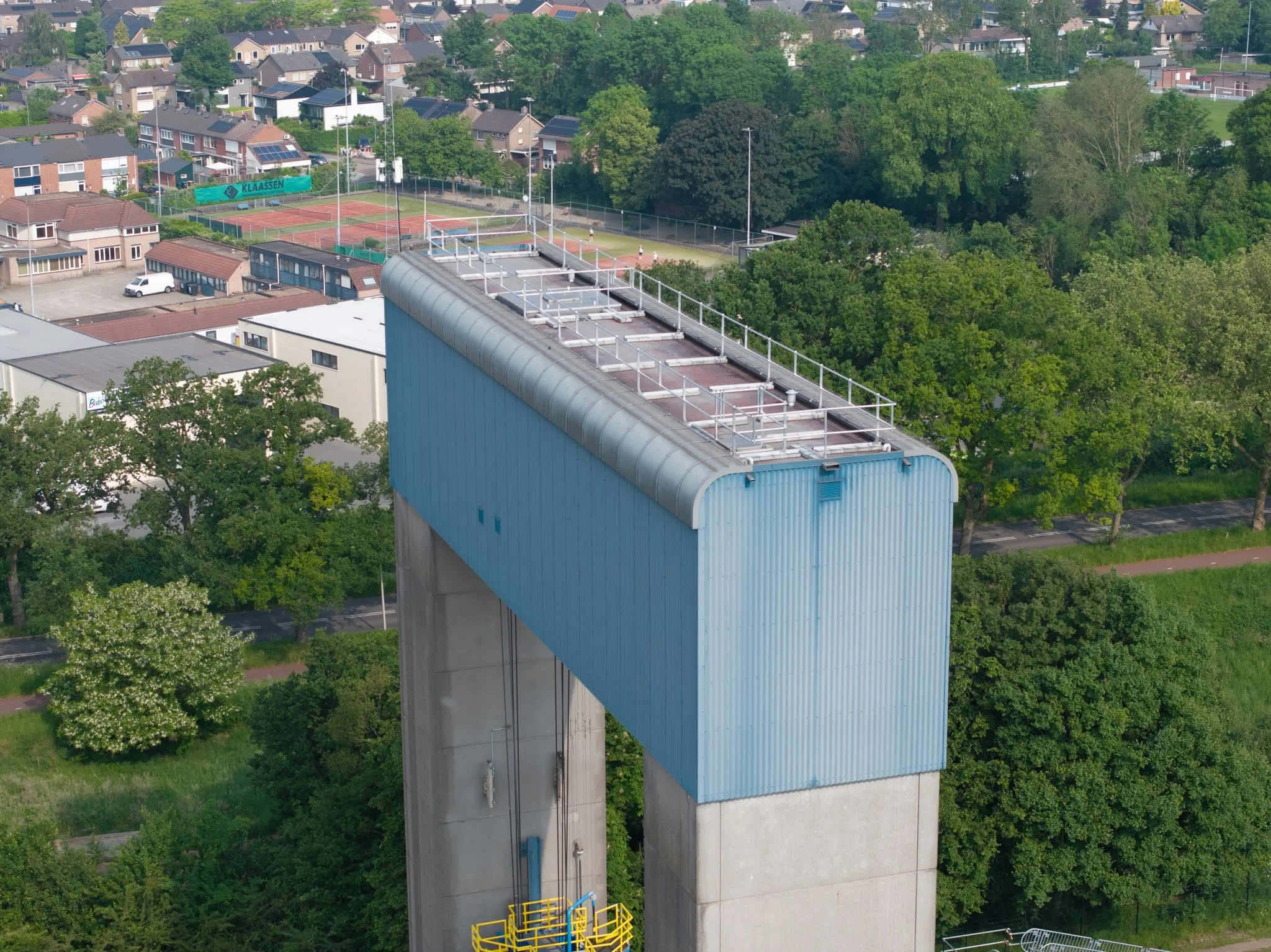 Close-up aerial view of the top of a blue lock structure at Weurt, with Protector Guardrail roof-edge protection along the upper edge.